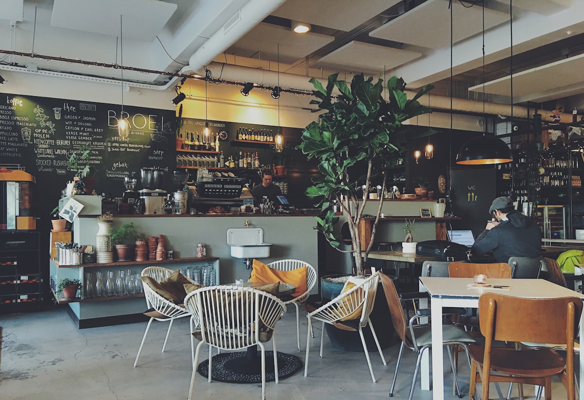 Warm cafe interior with wooden tables and pendant lights